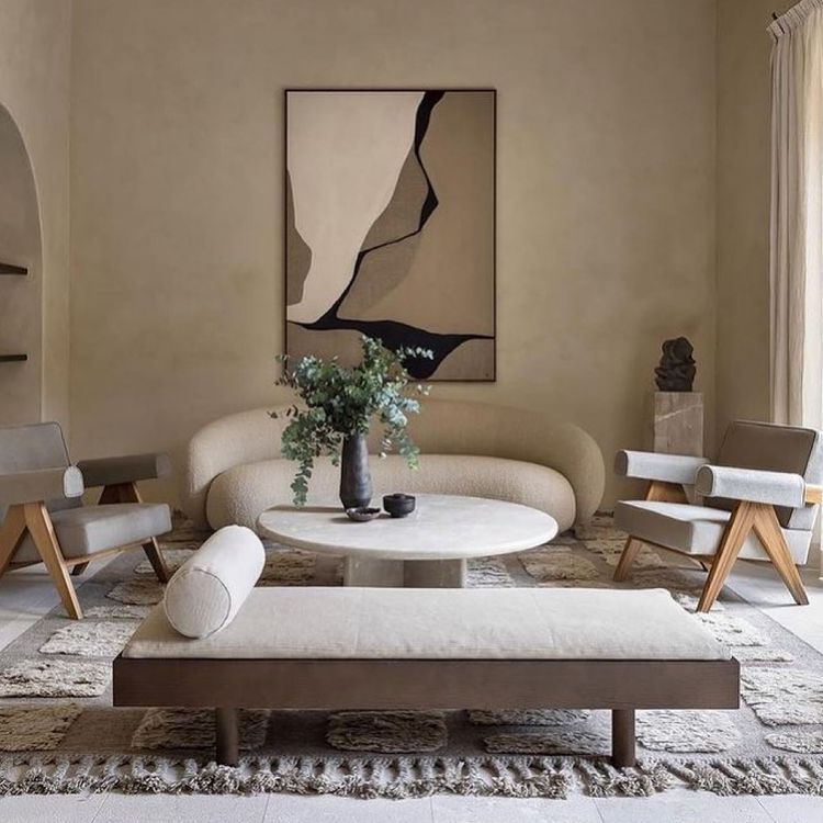 Neutral living room with wall art and a plant 